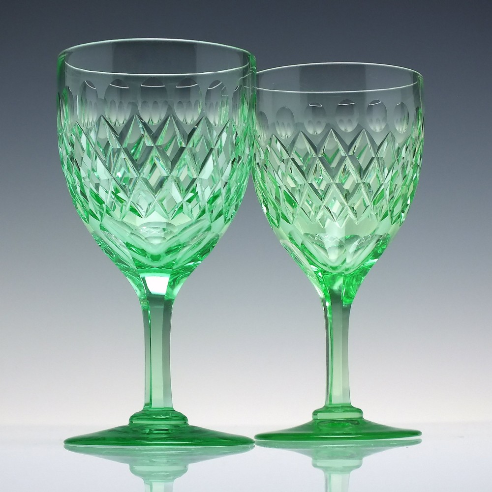 A set of six Victorian light green vaseline glass wine goblets featuring diamond-cut bowls and faceted stems. View II
