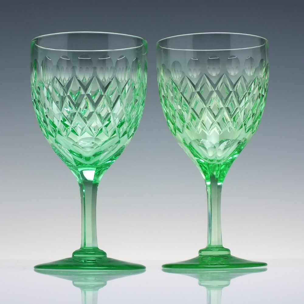 A set of six Victorian light green vaseline glass wine goblets featuring diamond-cut bowls and faceted stems. View III