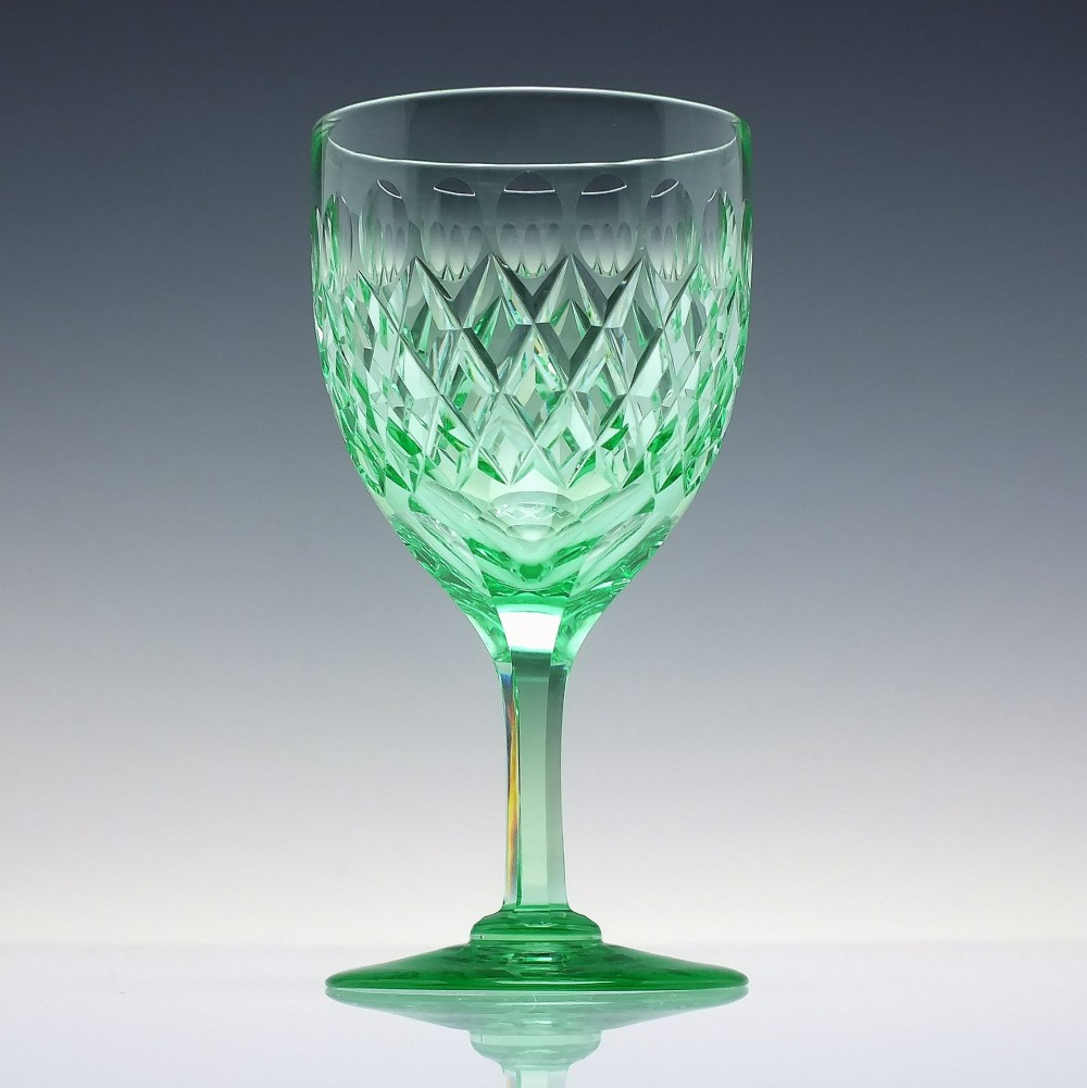 A set of six Victorian light green vaseline glass wine goblets featuring diamond-cut bowls and faceted stems. View IV