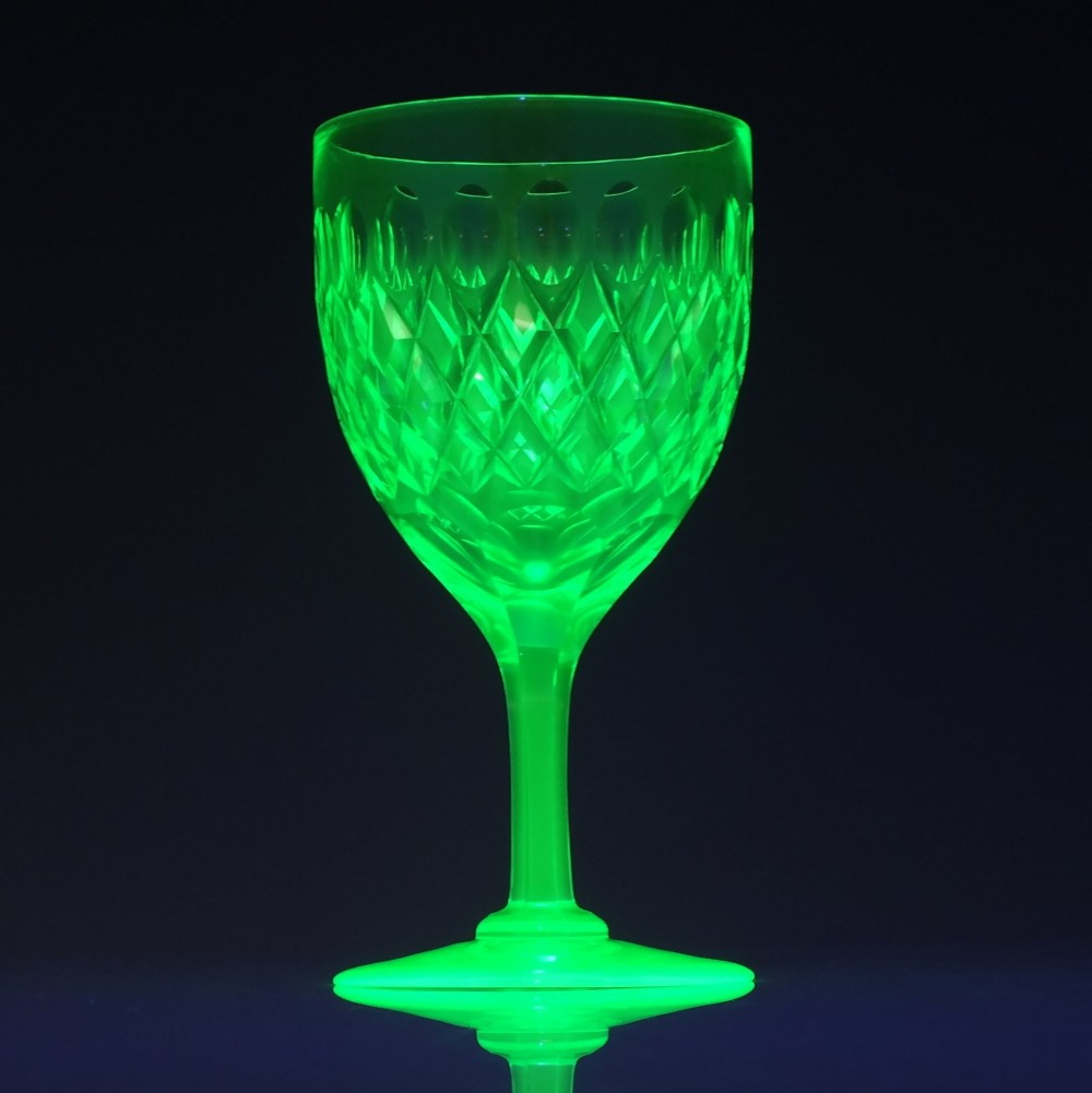 A set of six Victorian light green vaseline glass wine goblets featuring diamond-cut bowls and faceted stems. View V
