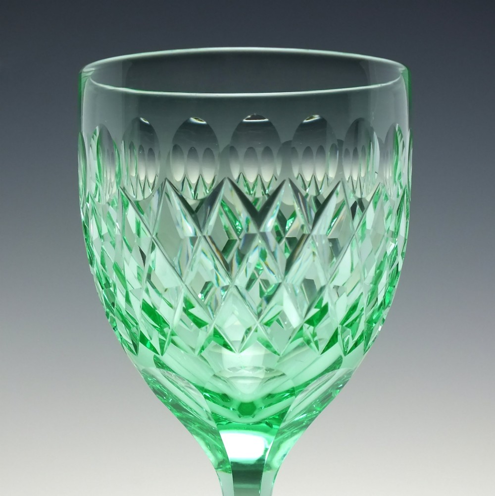 A set of six Victorian light green vaseline glass wine goblets featuring diamond-cut bowls and faceted stems. View VI