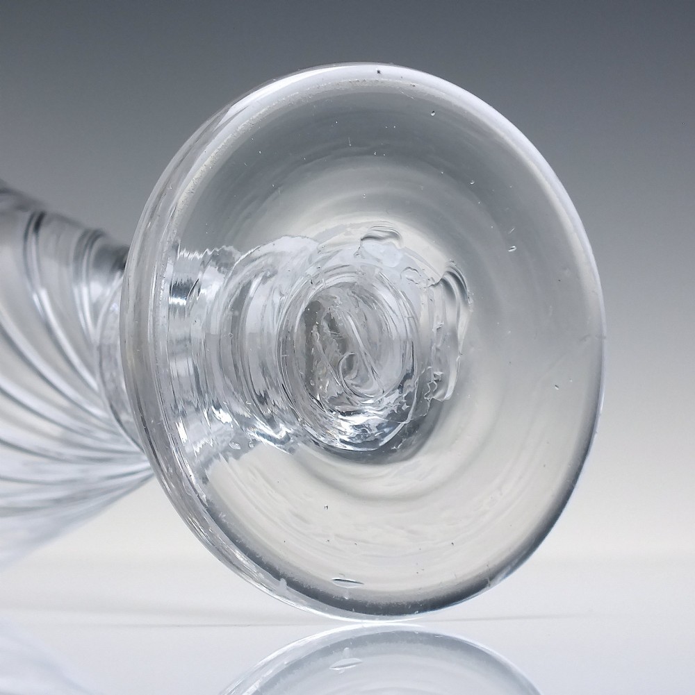 A clear Georgian lead glass ale goblet featuring half wrythen spiral moulding on the conical bowl and a knopped stem. View VI