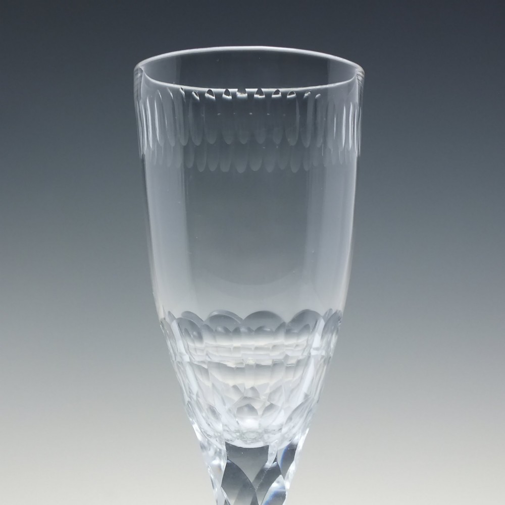 An 18th-century clear lead crystal ale glass featuring a faceted stem, a wide conical foot, and geometric cut decoration on the bowl. View IV
