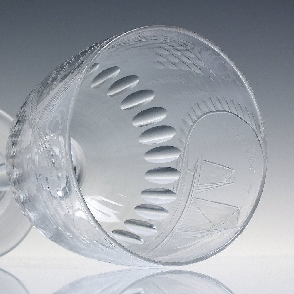 A pair of clear glass Victorian wine goblets featuring wheel-engraved sailing ships, inscriptions, and cut oval fluting around the lower bowls. View XI