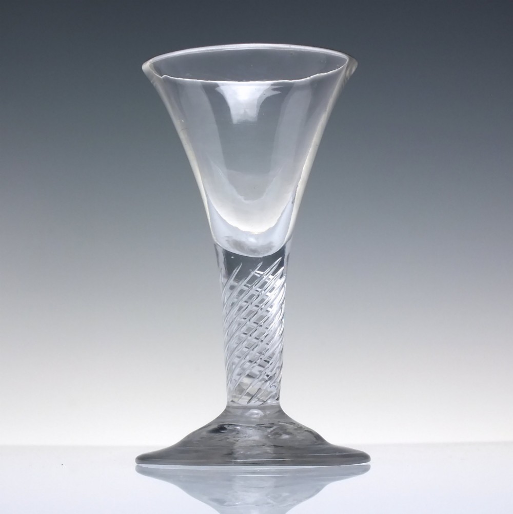 A clear Georgian dram glass featuring a flared trumpet bowl, a multi-spiral air twist stem, and a broad conical foot. View II