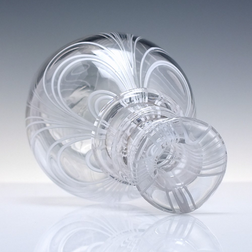 A clear lead glass Regency Prussian-shaped personal spirit decanter decorated with combed opaque white trailing and fitted with a matching glass stopper. View VI
