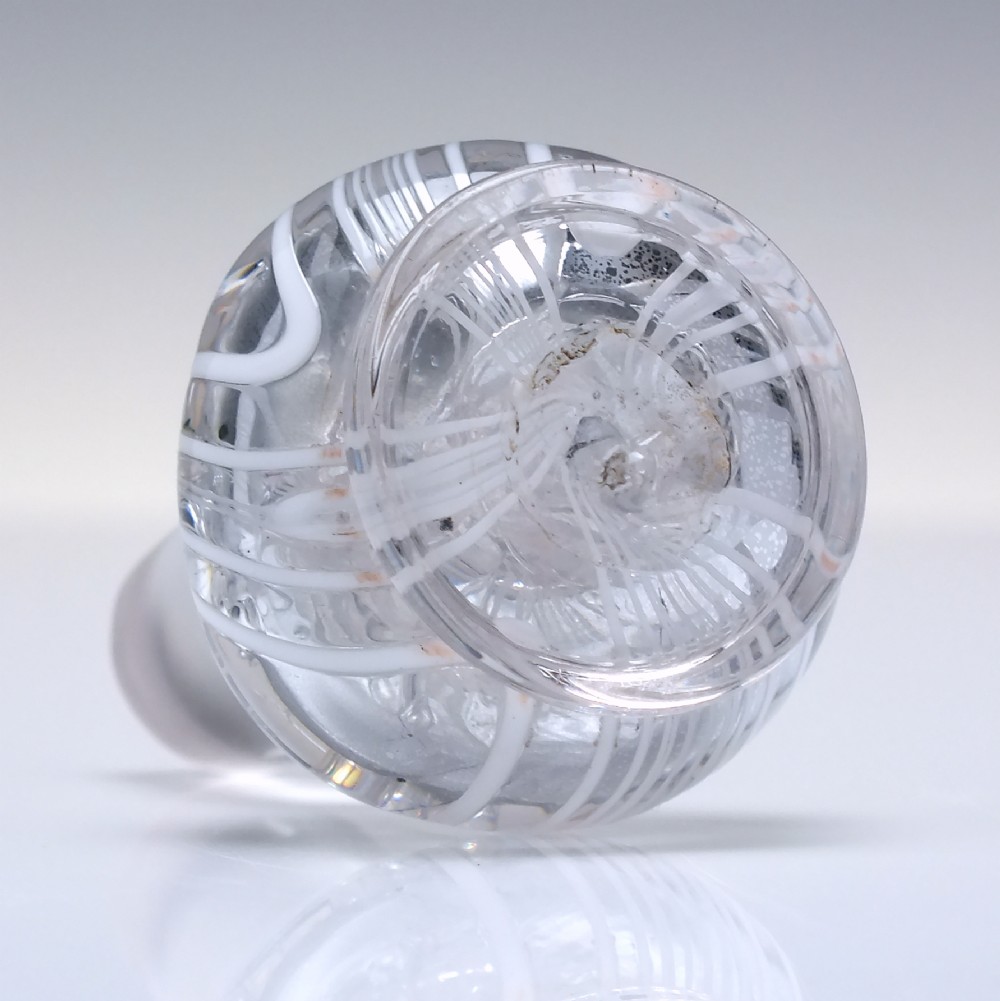 A clear lead glass Regency Prussian-shaped personal spirit decanter decorated with combed opaque white trailing and fitted with a matching glass stopper. View X