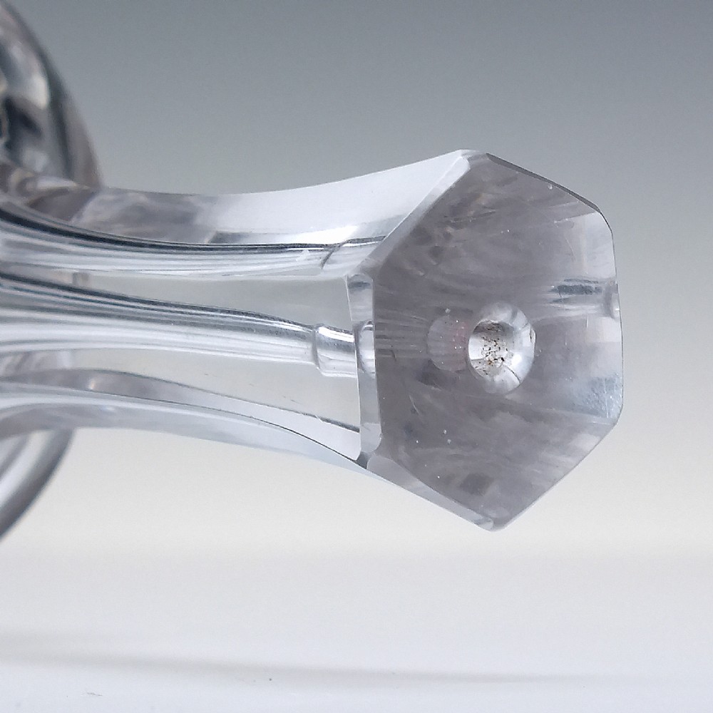 An 18th-century clear glass sugar loaf bitters bottle featuring a faceted slender neck, cut panel base, and wheel-engraved lettering spelling BITTERS surrounded by floral swags. View VI
