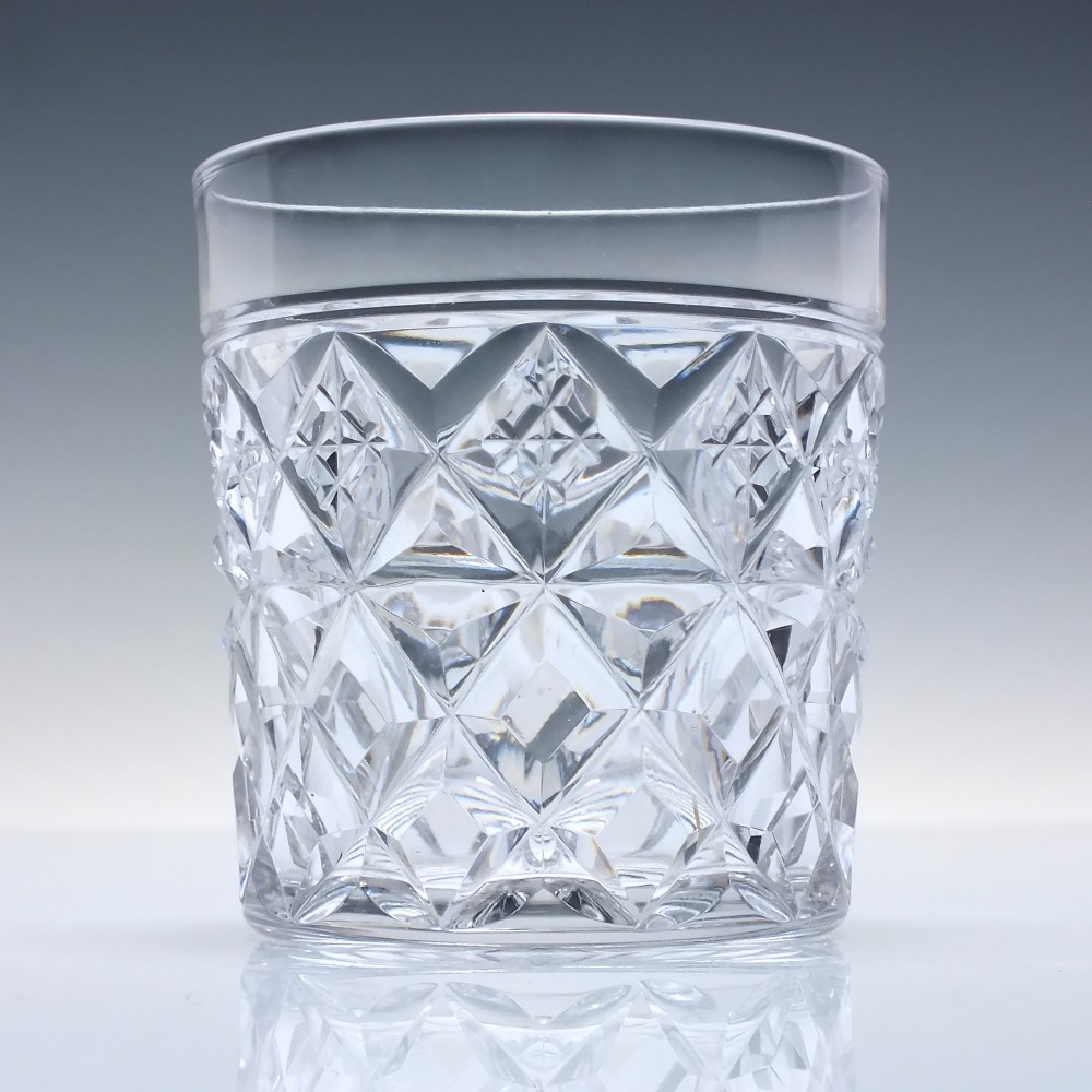 A pair of clear cut-crystal whisky tumblers featuring a deep diamond geometric pattern and smooth polished rims. View III