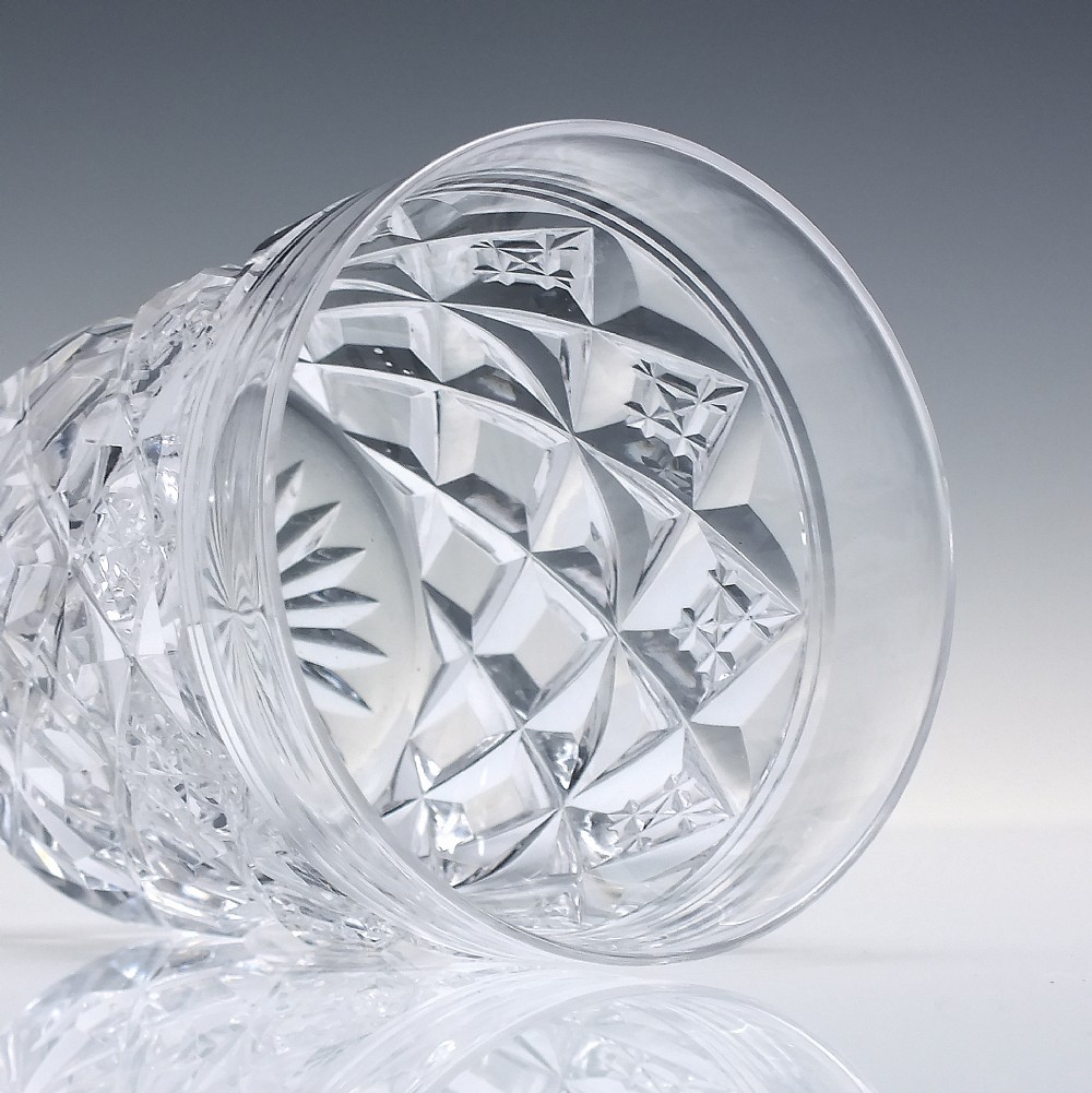 A pair of clear cut-crystal whisky tumblers featuring a deep diamond geometric pattern and smooth polished rims. View IV