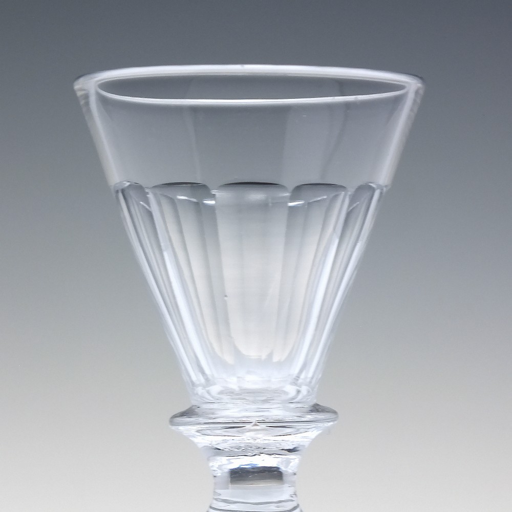 A pair of clear cut-glass Georgian dram glasses featuring conical bowls with vertical flutes and knopped stems on circular footed bases. View III