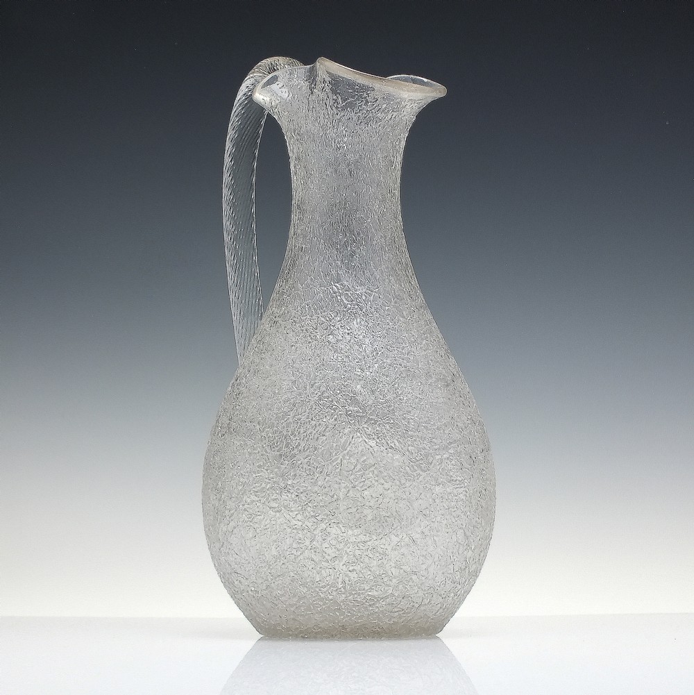 A late 19th-century Victorian clear overshot glass champagne jug with a textured ice-glass surface, flared spout, and an applied ribbed clear handle. View III