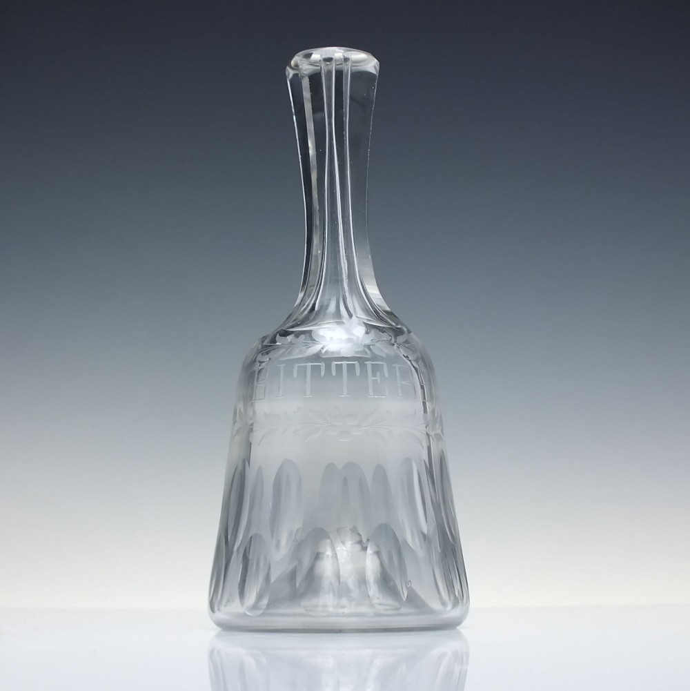 A pair of 18th-century clear glass sugar loaf bitters bottles featuring facet-cut long necks, hand-engraved floral garlands, and the word BITTERS cut into the body. View III