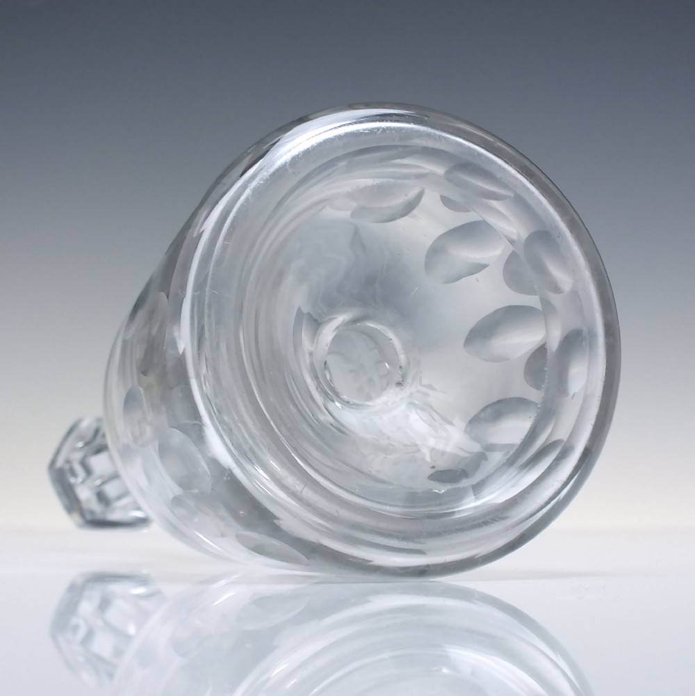 A pair of 18th-century clear glass sugar loaf bitters bottles featuring facet-cut long necks, hand-engraved floral garlands, and the word BITTERS cut into the body. View VI