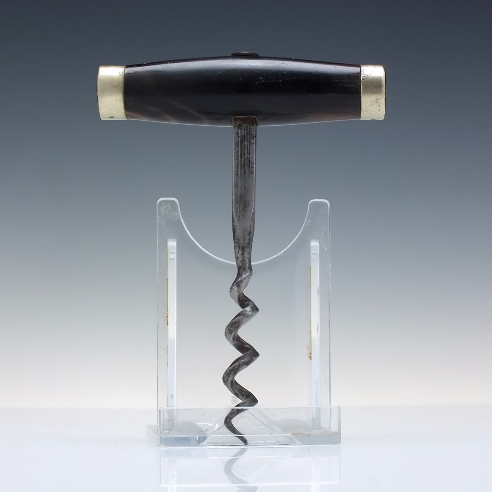 A Victorian direct-pull corkscrew featuring a T-bar handle made of dark polished horn capped with silver-plated ends and a steel helix worm.