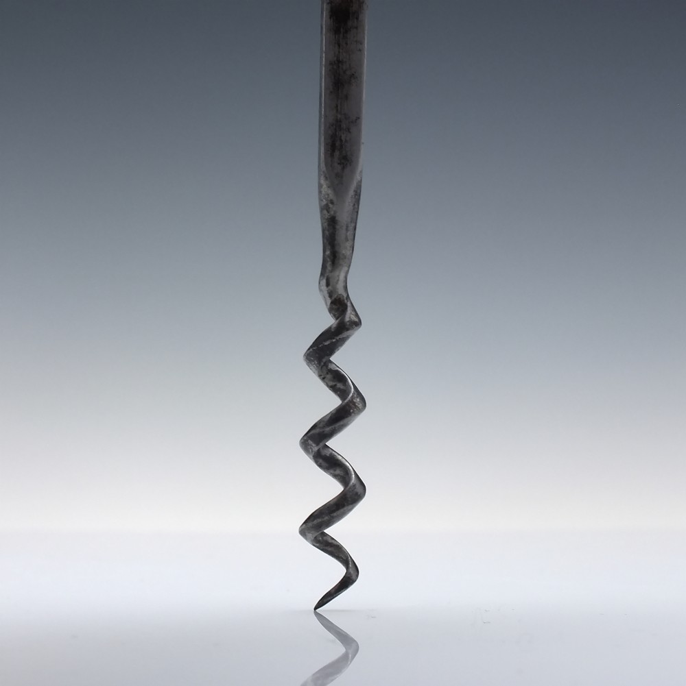 A Victorian direct-pull corkscrew featuring a T-bar handle made of dark polished horn capped with silver-plated ends and a steel helix worm. View III