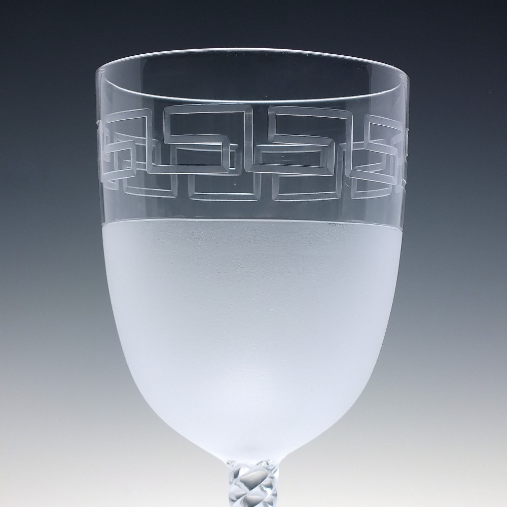 A pair of clear and frosted Edwardian glass wine goblets featuring a Greek key engraved border and spiral twisted stems. View III