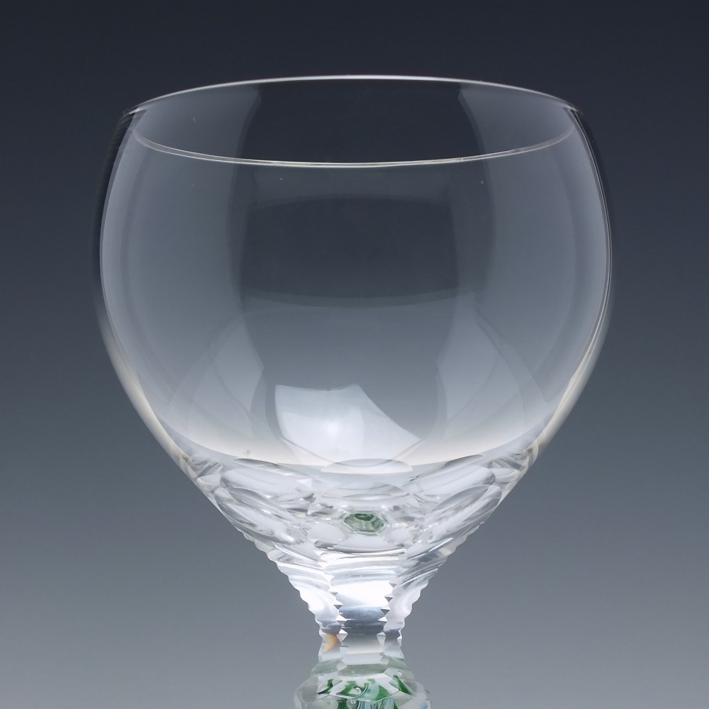A pair of clear glass wine goblets featuring round bowls and tall stems decorated with internal green and white opaque twists. View III