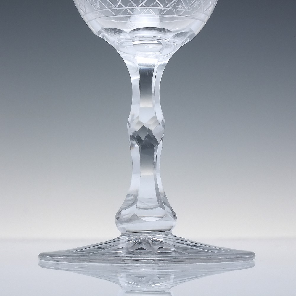 A pair of clear glass Victorian wine goblets featuring star and diamond pattern engravings with faceted stems. View III