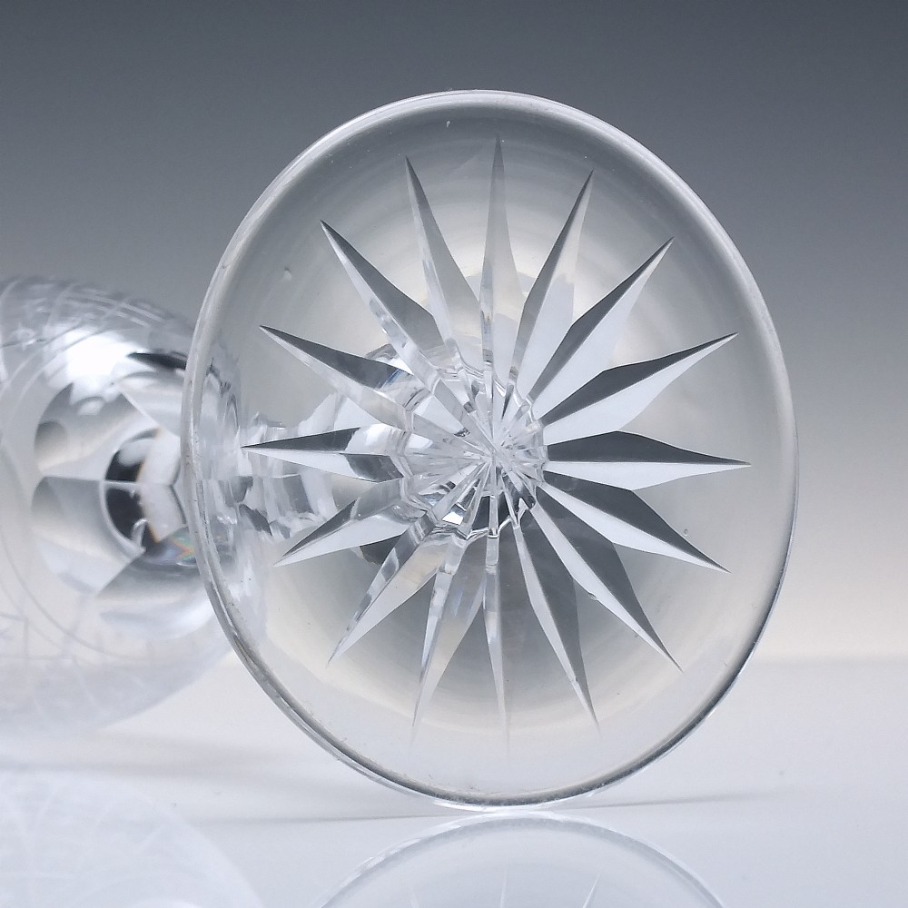 A pair of clear glass Victorian wine goblets featuring star and diamond pattern engravings with faceted stems. View VI
