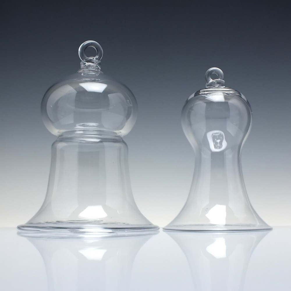 A clear hand-blown glass bell cloche dome featuring a looped glass top handle and a flared base rim. View II