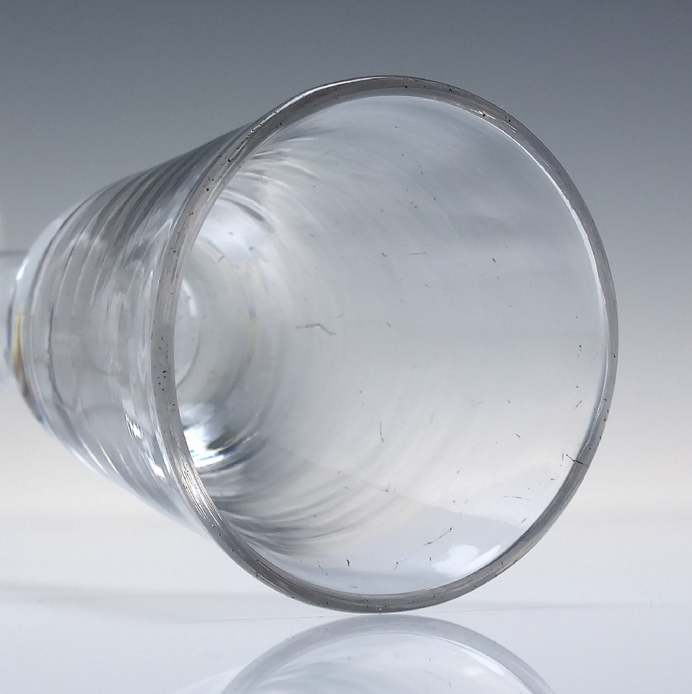 A clear Georgian lead glass wine glass featuring an internal white opaque twist stem and a stepped helmet foot. View V