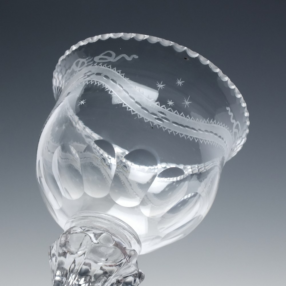 An 18th-century Georgian clear glass sweetmeat vessel featuring a wheel-engraved rim, faceted pedestal stem, and domed circular foot. View V