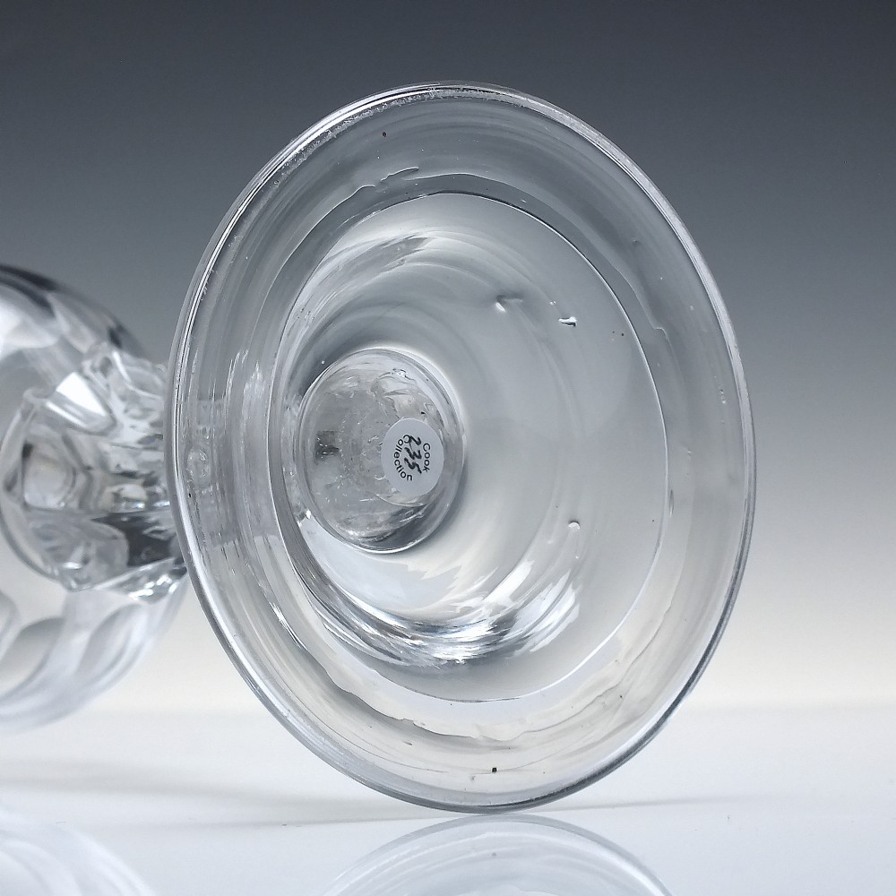 An 18th-century Georgian clear glass sweetmeat vessel featuring a wheel-engraved rim, faceted pedestal stem, and domed circular foot. View VII