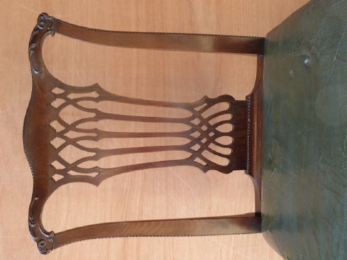 A pair of Chippendale style Irish mahogany dining chairs with carved pierced splats and green leather upholstered seats. View IV
