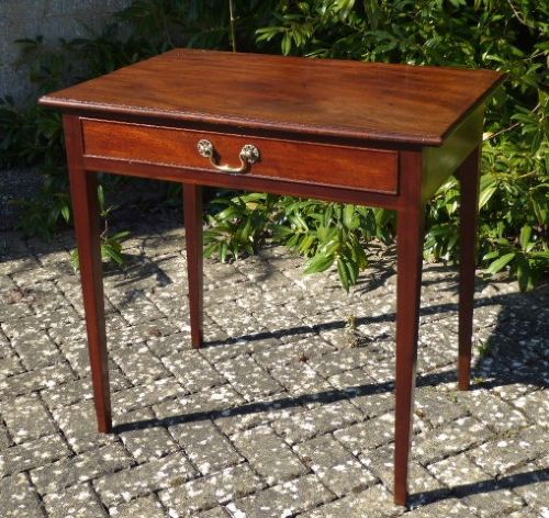 A Georgian mahogany side table featuring a single drawer with a central brass handle and slender square tapered legs. View II