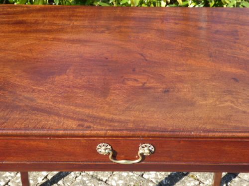 A Georgian mahogany side table featuring a single drawer with a central brass handle and slender square tapered legs. View IV