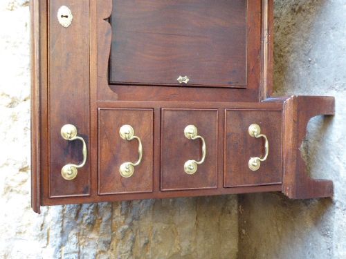 An antique Georgian mahogany kneehole desk featuring brass swan-neck handles, a central recessed cupboard, and bracket feet. View III