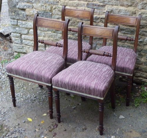 A set of four Regency mahogany dining chairs featuring carved rope-twist cross rails, reeded uprights, turned front legs, and plum striped upholstered seats. View II