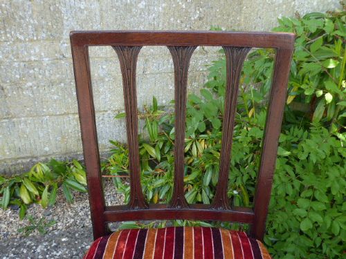 Set of four late 18th-century Georgian mahogany dining chairs featuring pierced vertical splat backs and striped upholstered seats. View IV