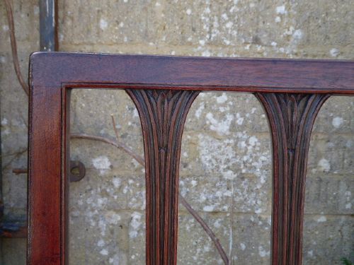 Set of four late 18th-century Georgian mahogany dining chairs featuring pierced vertical splat backs and striped upholstered seats. View V
