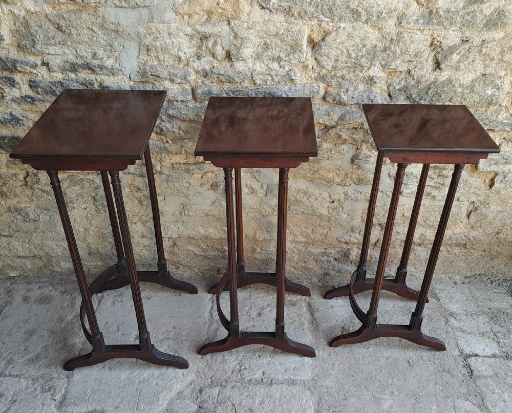 Nest of three mahogany tables