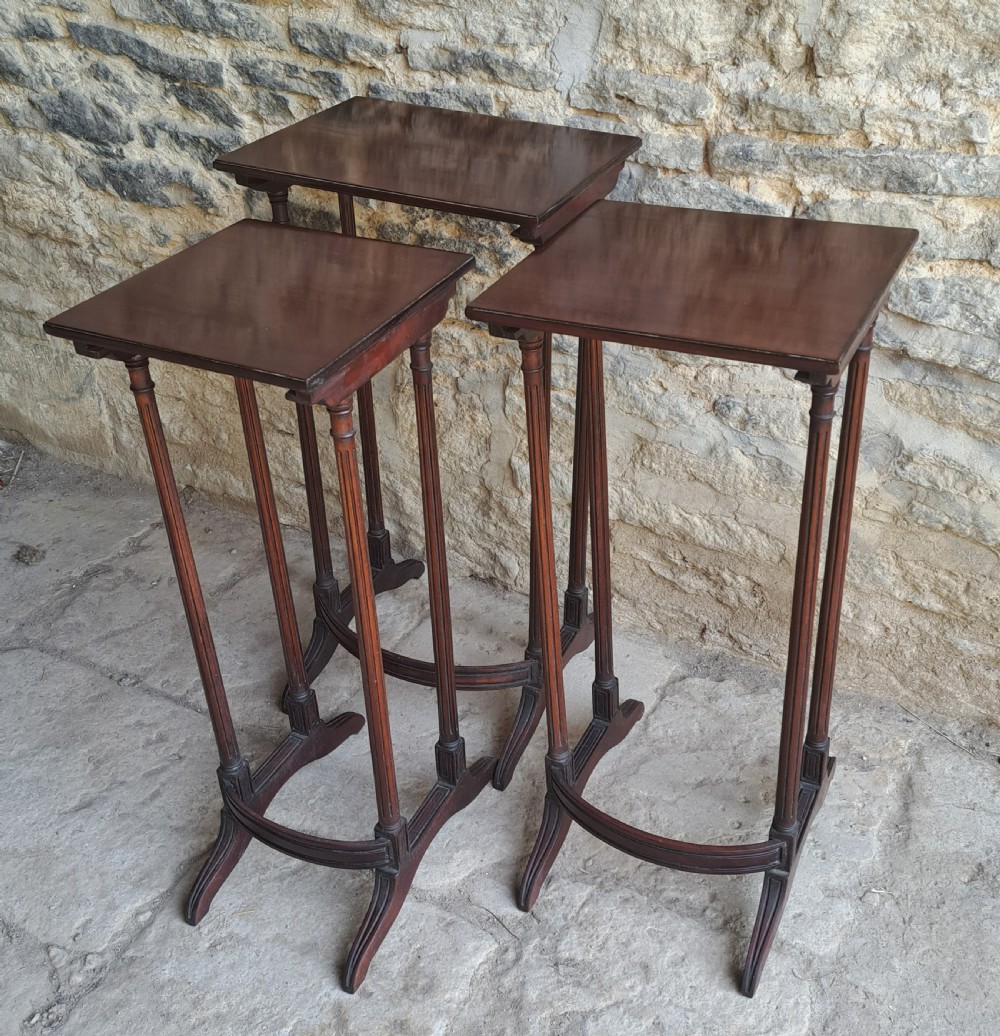 Nest of three mahogany tables View II