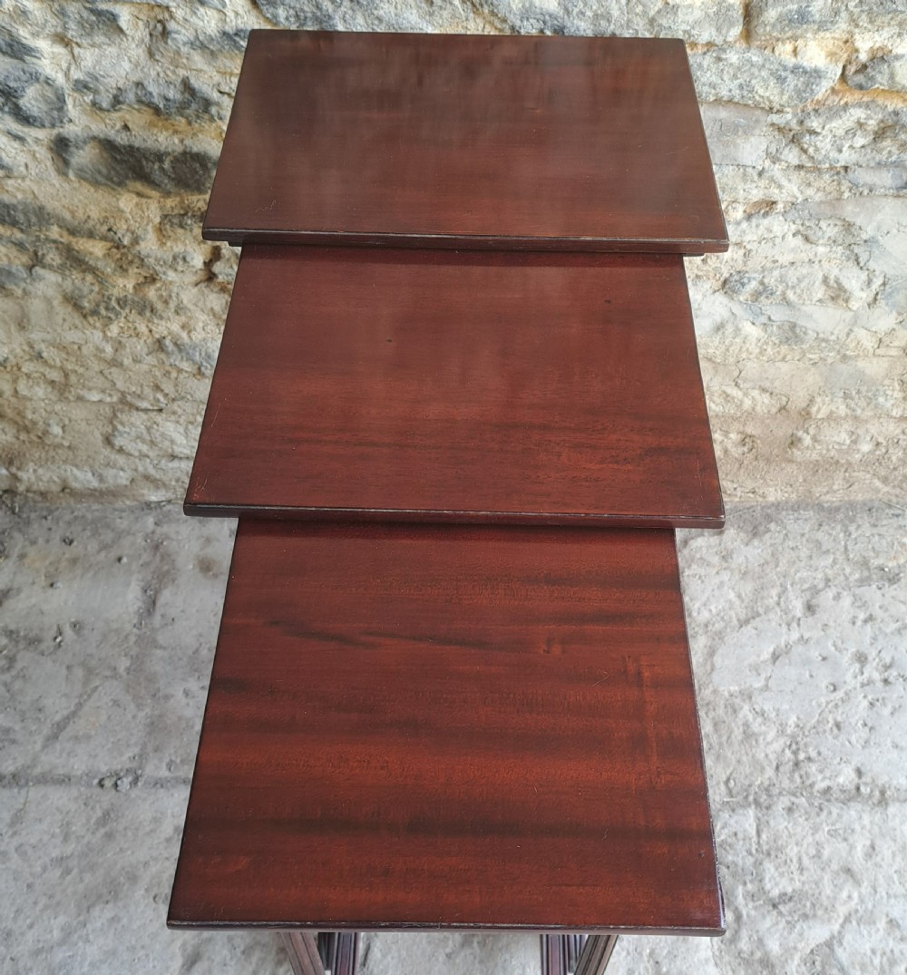 Nest of three mahogany tables View IV