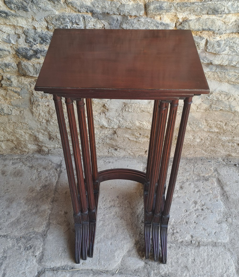 Nest of three mahogany tables View V