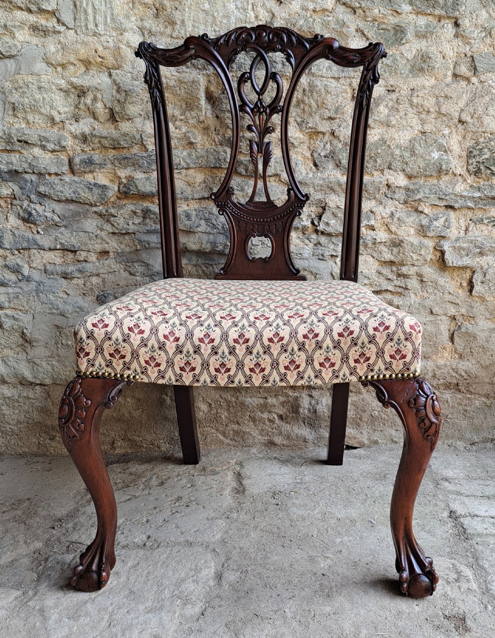 A mid-19th-century mahogany Chippendale style side chair featuring a carved pierced splat back, patterned upholstery, and cabriole front legs with ball-and-claw feet. View II