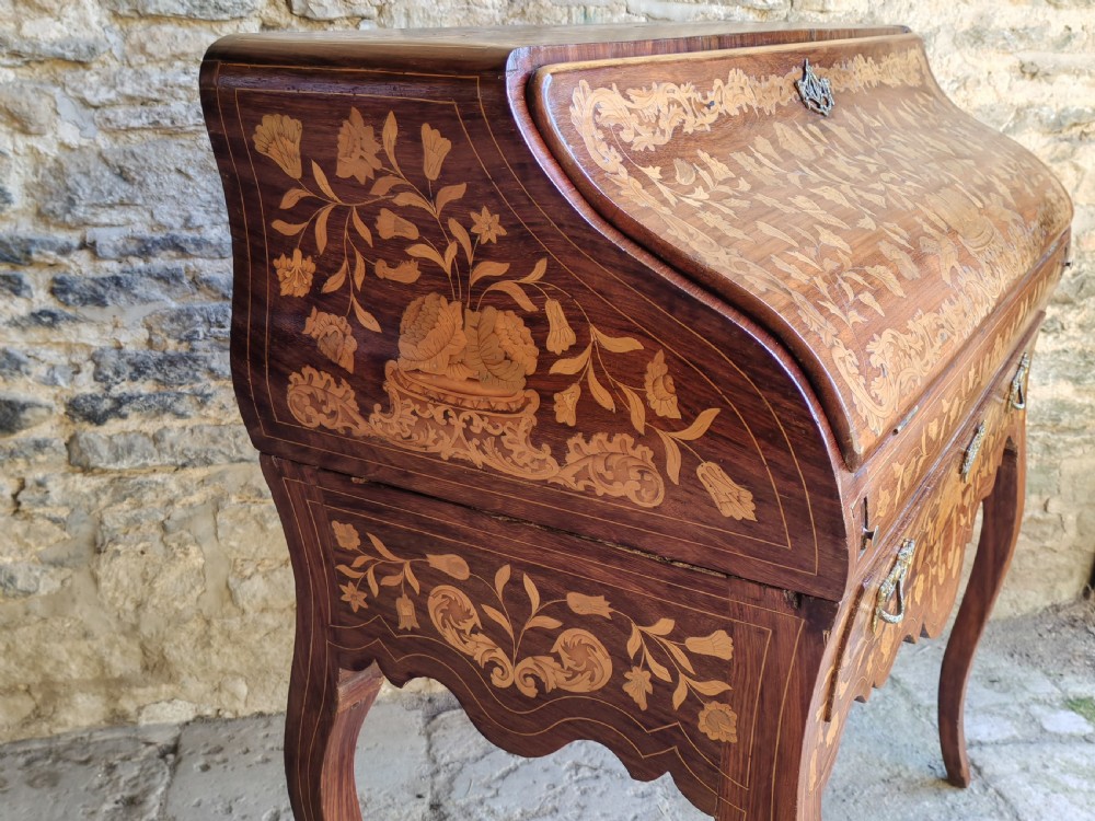 An antique Dutch mahogany writing bureau with intricate floral wood marquetry, a sloped fall front, a single drawer, and cabriole legs. View III