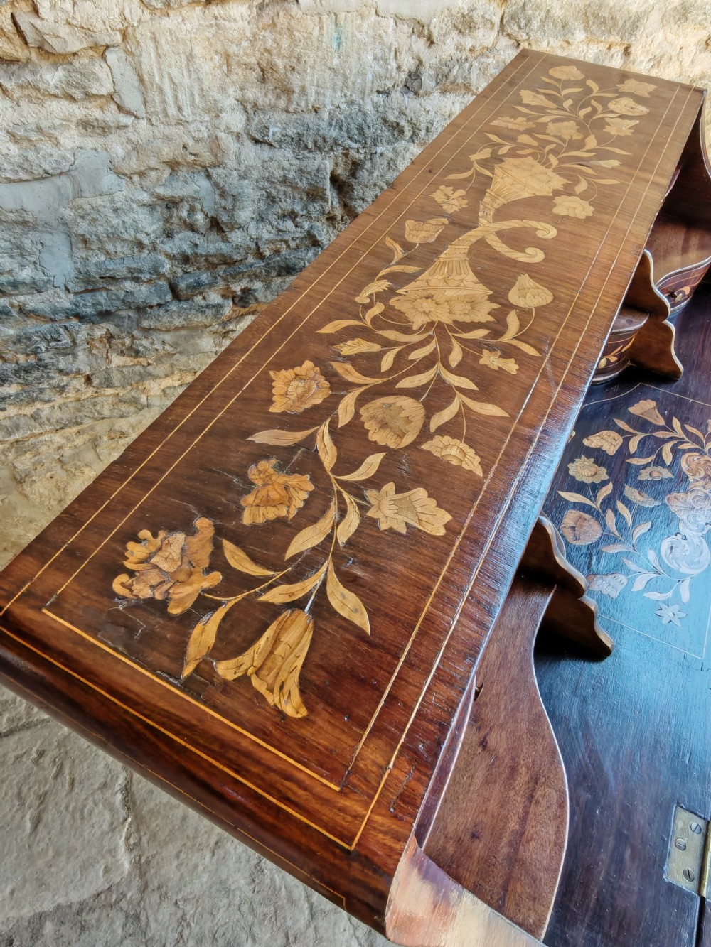 An antique Dutch mahogany writing bureau with intricate floral wood marquetry, a sloped fall front, a single drawer, and cabriole legs. View VII