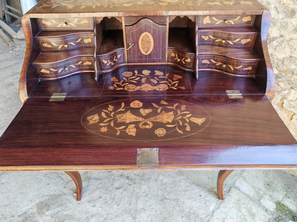 An antique Dutch mahogany writing bureau with intricate floral wood marquetry, a sloped fall front, a single drawer, and cabriole legs. View IX