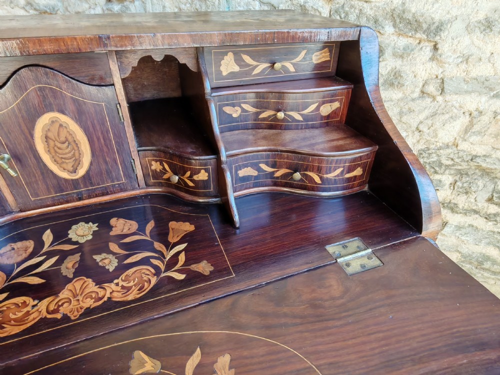 An antique Dutch mahogany writing bureau with intricate floral wood marquetry, a sloped fall front, a single drawer, and cabriole legs. View XII