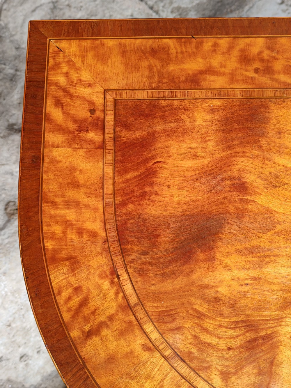 A late eighteenth-century Georgian satinwood demi-lune card table featuring inlaid crossbanding and four square tapered legs. View IV