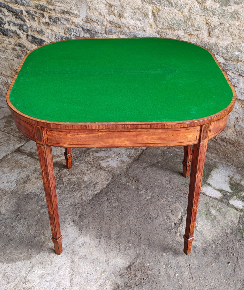 A late eighteenth-century Georgian satinwood demi-lune card table featuring inlaid crossbanding and four square tapered legs. View VIII