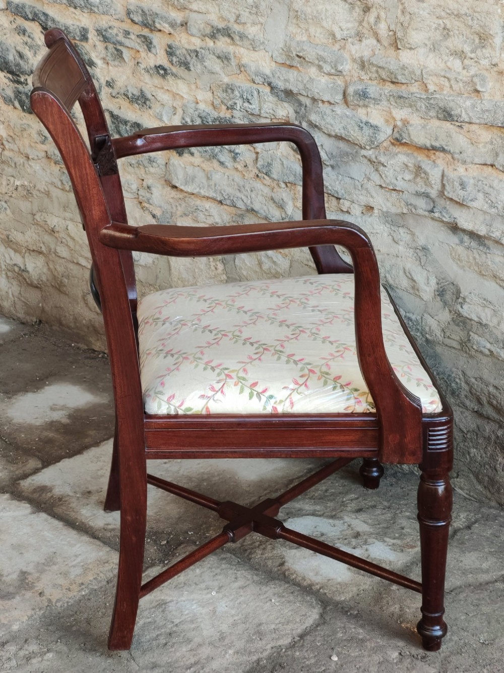 A Georgian mahogany carver armchair featuring reeded arms, a central carved splat, an upholstered seat, turned front legs, and an X-frame stretcher. View VIII