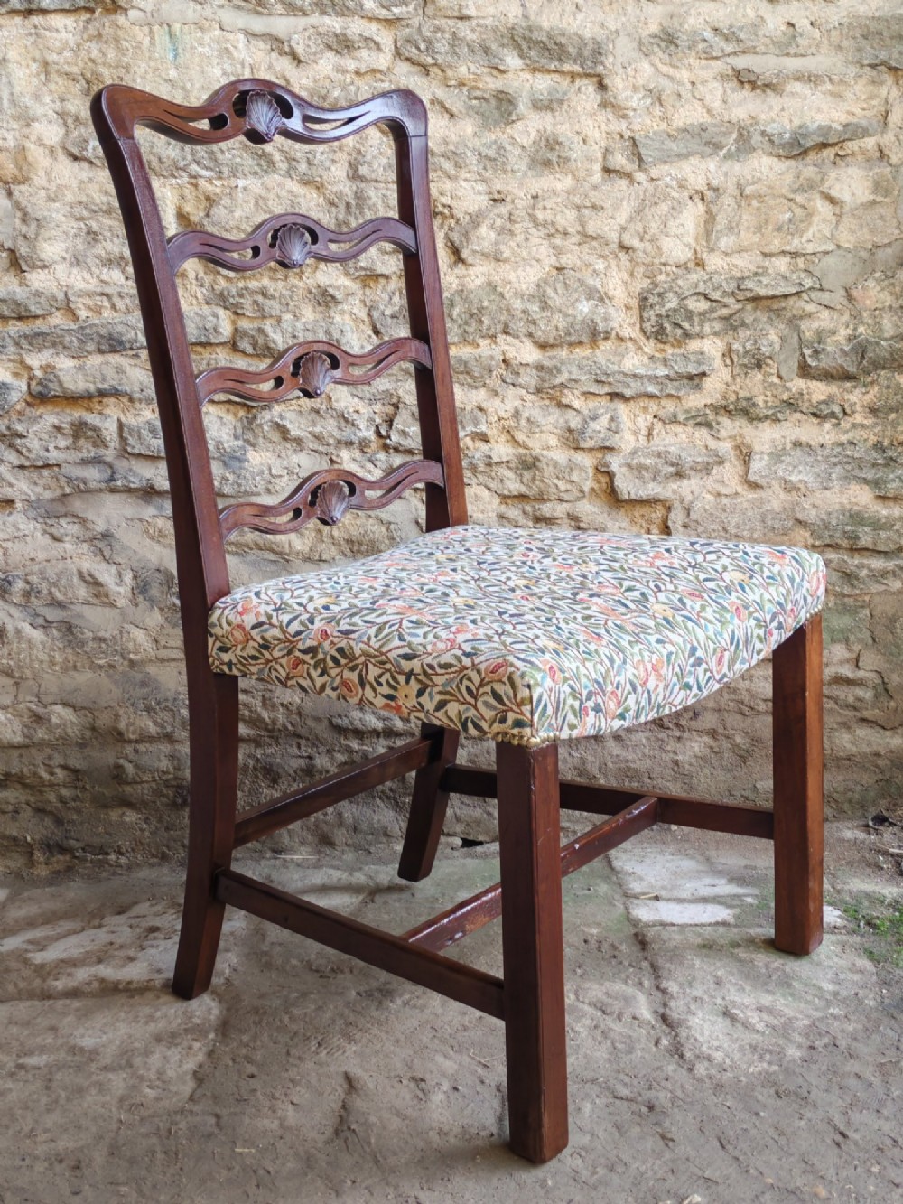 A Victorian mahogany ladderback side chair featuring four carved shell motifs on the back rails and a floral tapestry drop-in seat. View II