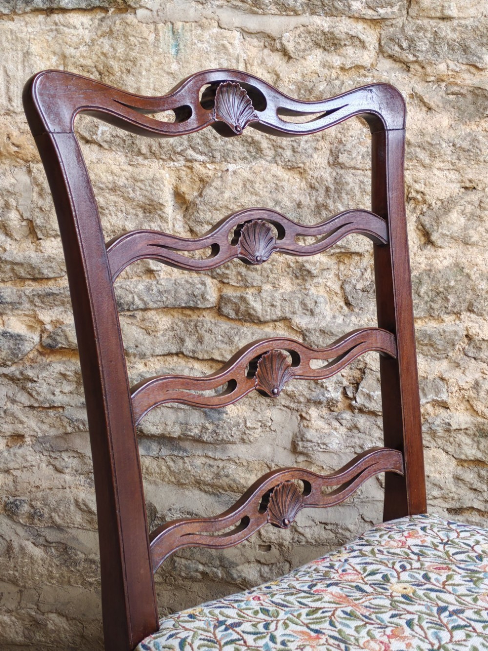 A Victorian mahogany ladderback side chair featuring four carved shell motifs on the back rails and a floral tapestry drop-in seat. View III
