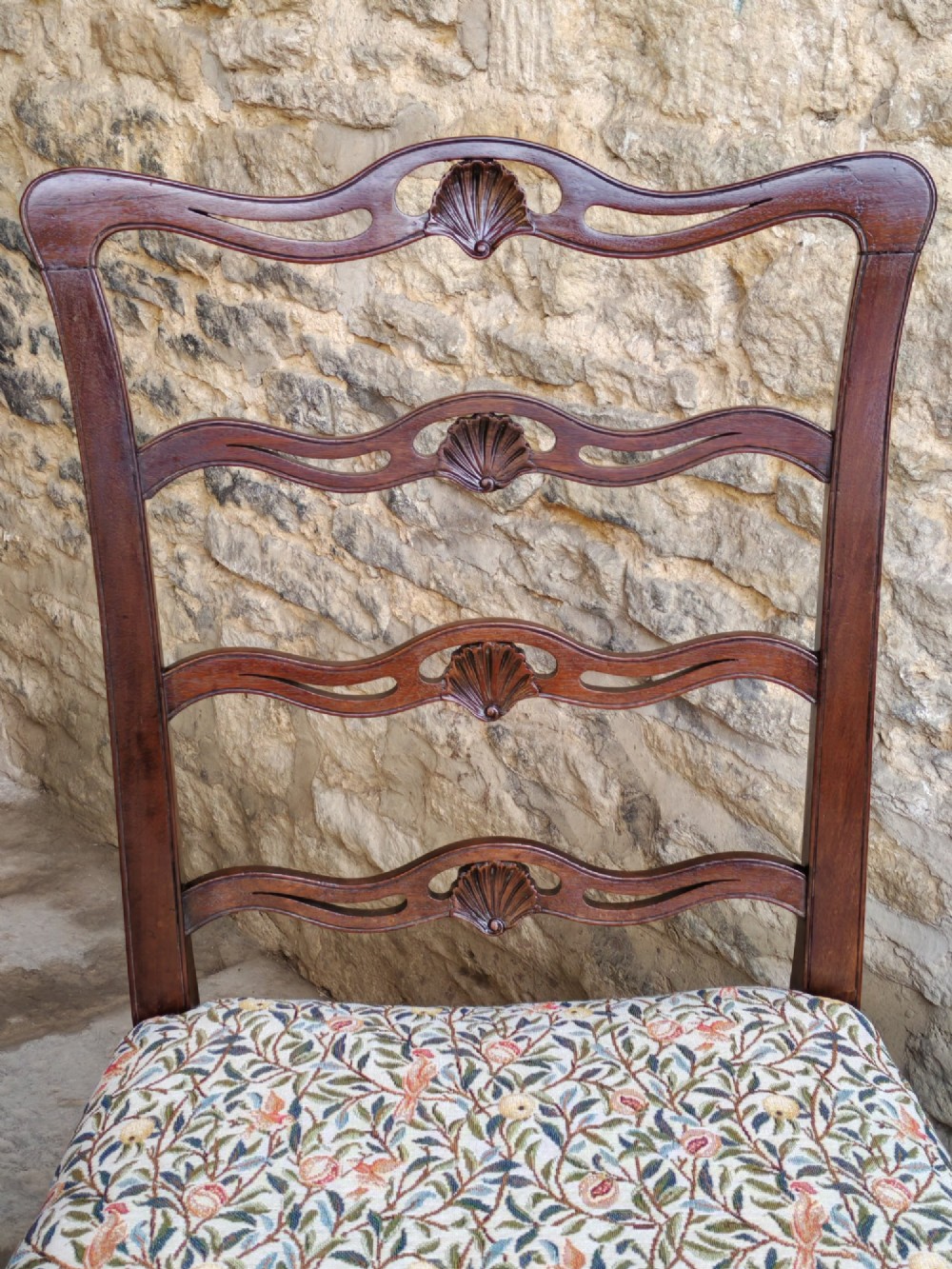 A Victorian mahogany ladderback side chair featuring four carved shell motifs on the back rails and a floral tapestry drop-in seat. View IV